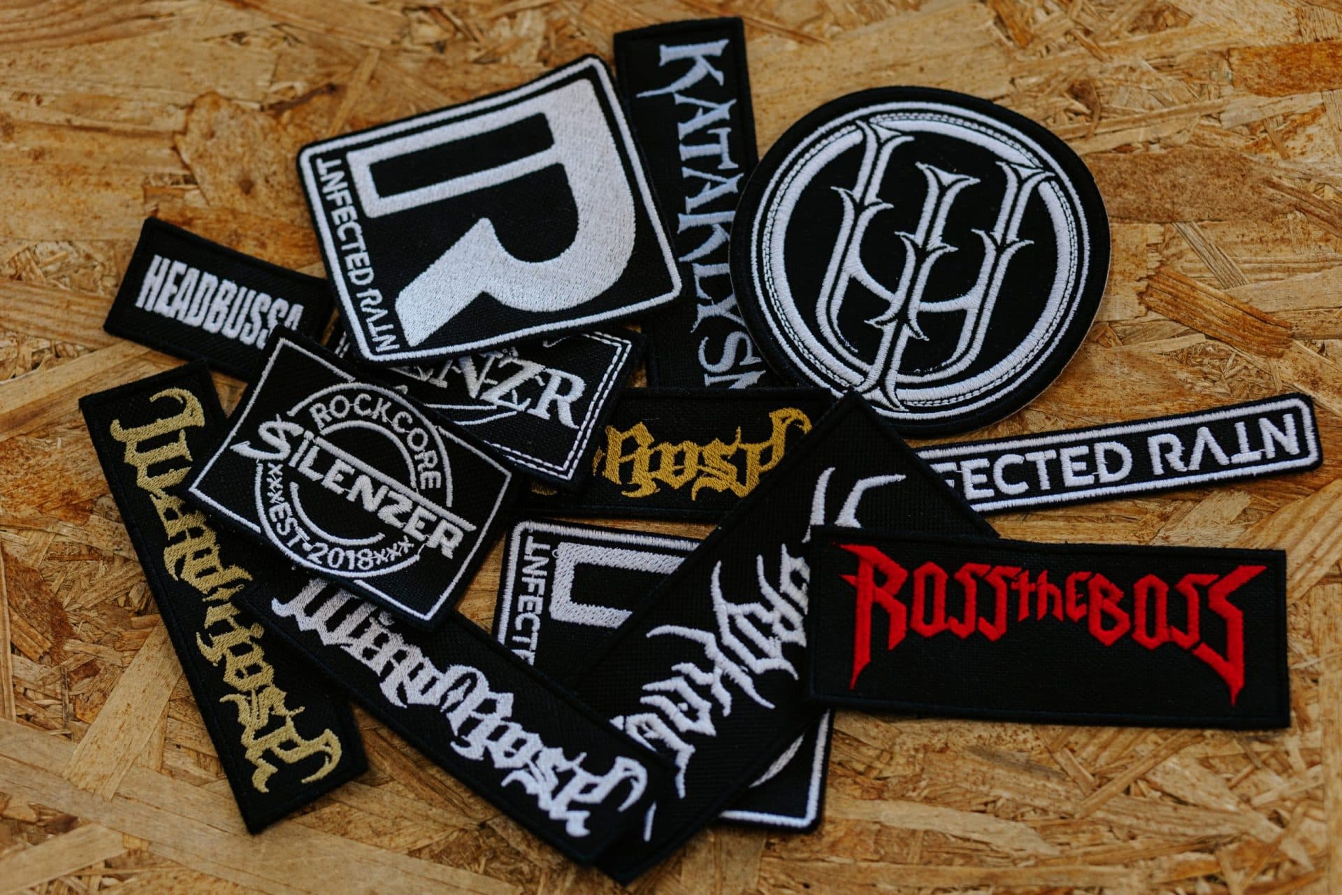 Custom embroidered metal band patches collection including SLAYER and Infected Rain logos