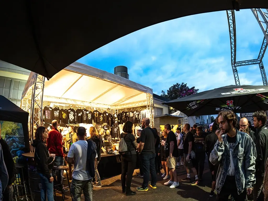 Outdoor festival merchandise booth with metal band t-shirts at European music festival